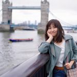 Dr Yu by the Thames, with Tower Bridge in the background.