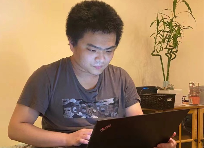 Researcher Zhuangkun Wei working hard on a laptop